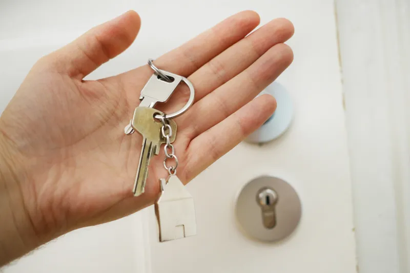 Person holding the keys to their new rental home.